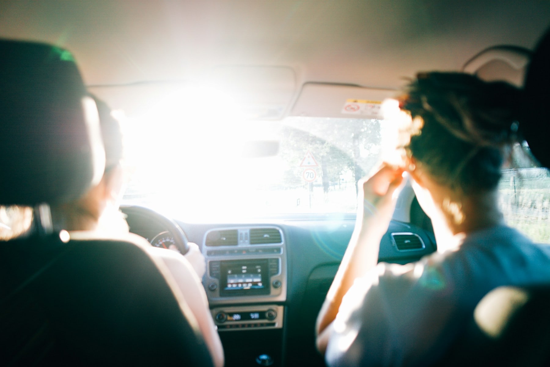 Friends travelling together on a sunlit road trip